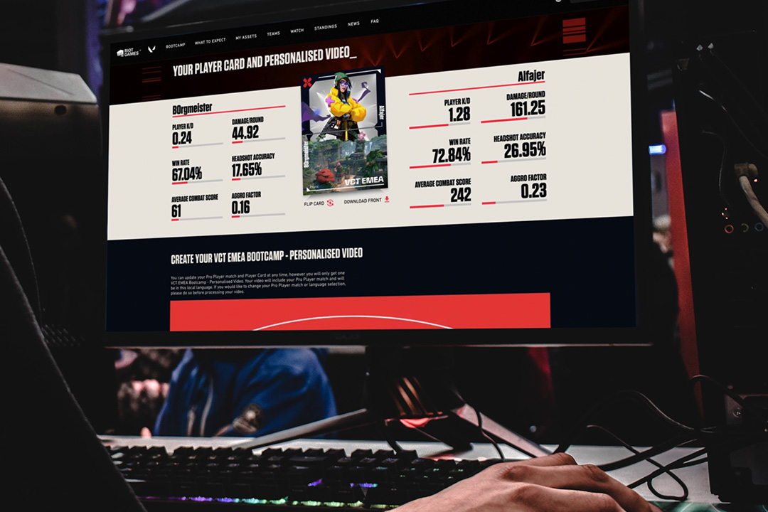 A person uses a computer with a gaming stats website on the monitor, showing a player card, personalized video section, and detailed Riot Games VCT performance statistics in a bold interface.