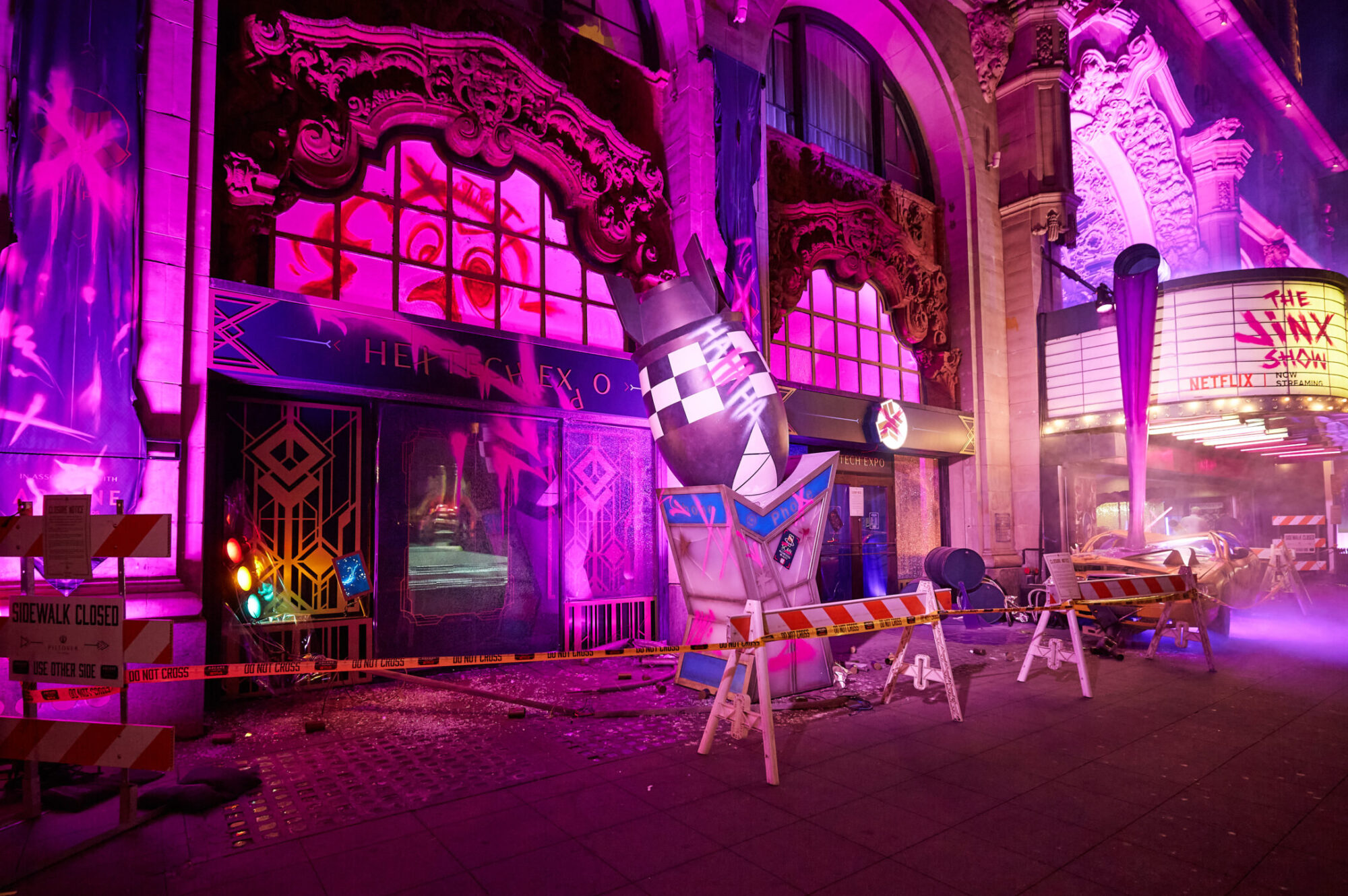 A street scene at night shows a theater entrance lit with purple and pink lights. Barricades, caution tape, and props block the sidewalk. The marquee reads The Shiny Show, with ornate architecture above—reminiscent of Netflix Arcane’s vivid style.