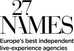 A simple black and white line illustration of a person sitting at a desk, working on a laptop—perhaps brainstorming ideas for an immersive marketing agency—with a coffee cup and a potted plant nearby.