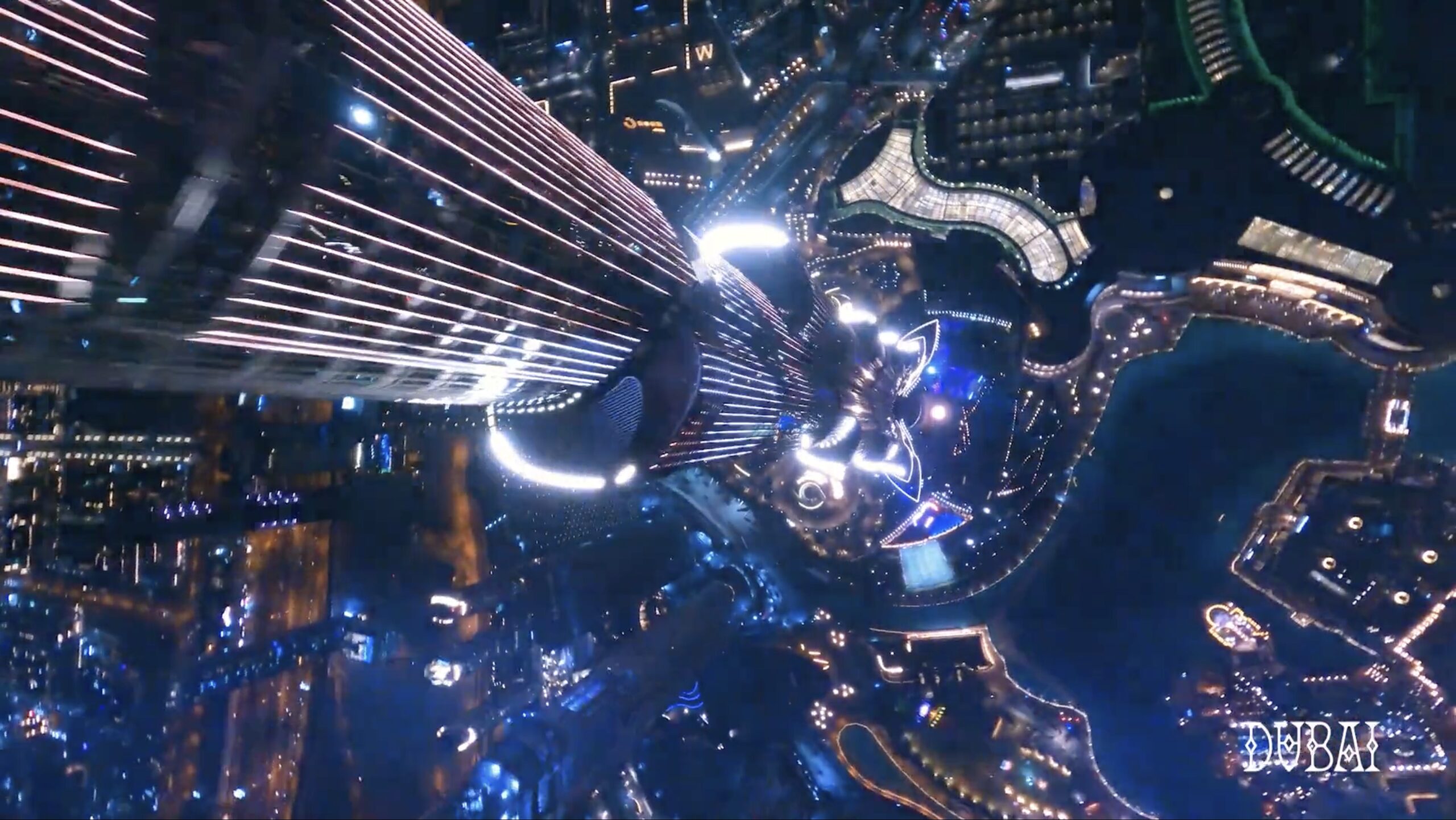 A nighttime aerial view looking straight down from the top of the Burj Khalifa, with bright lights illuminating the building and surrounding cityscape in Dubai, reminiscent of the vibrant visuals seen in Netflix Arcane.