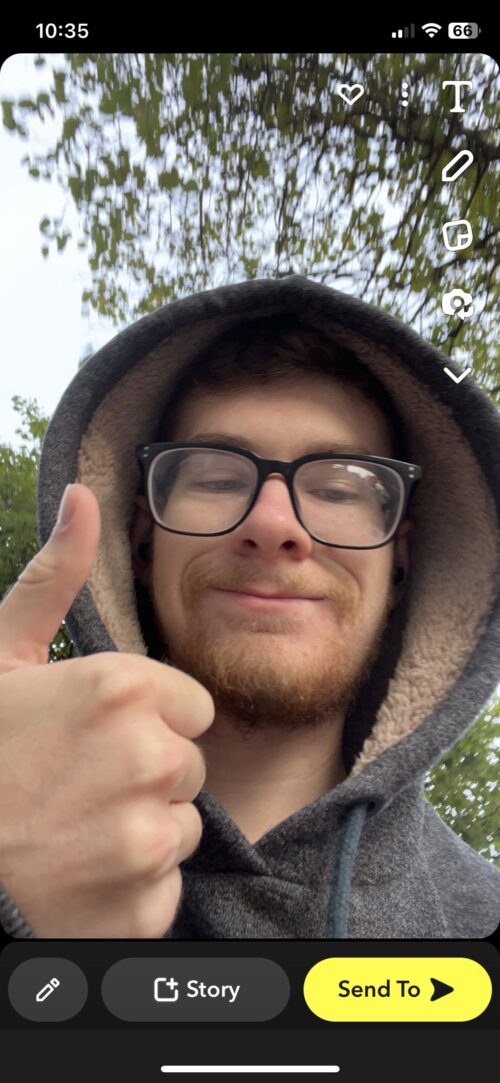 A person wearing glasses and a hooded sweatshirt gives a thumbs up and smiles at the camera outdoors, sharing experiential marketing lessons. Snapchat icons and the time (10:35) are visible at the top of the screen.