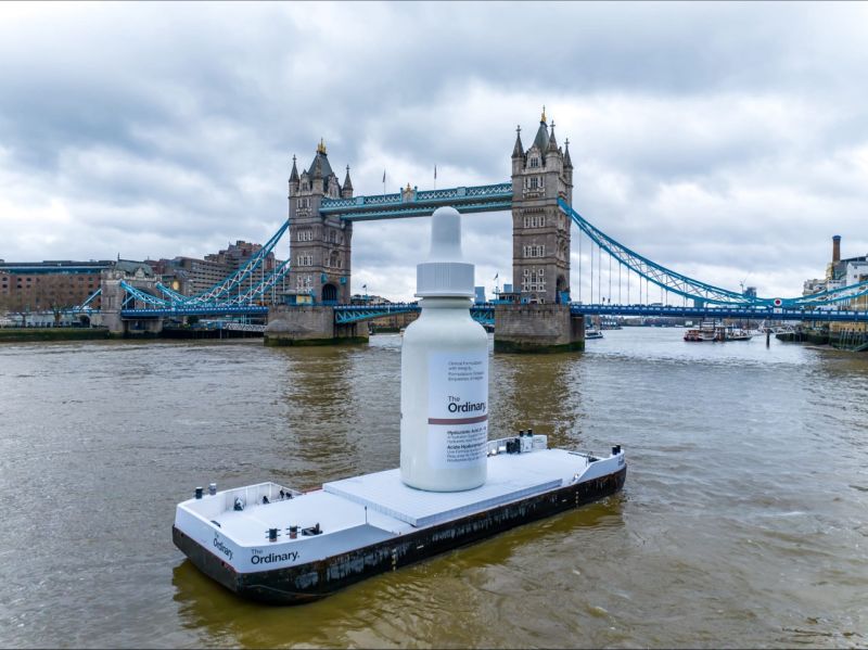 Image of a giant bottle of makeup floating on a river.